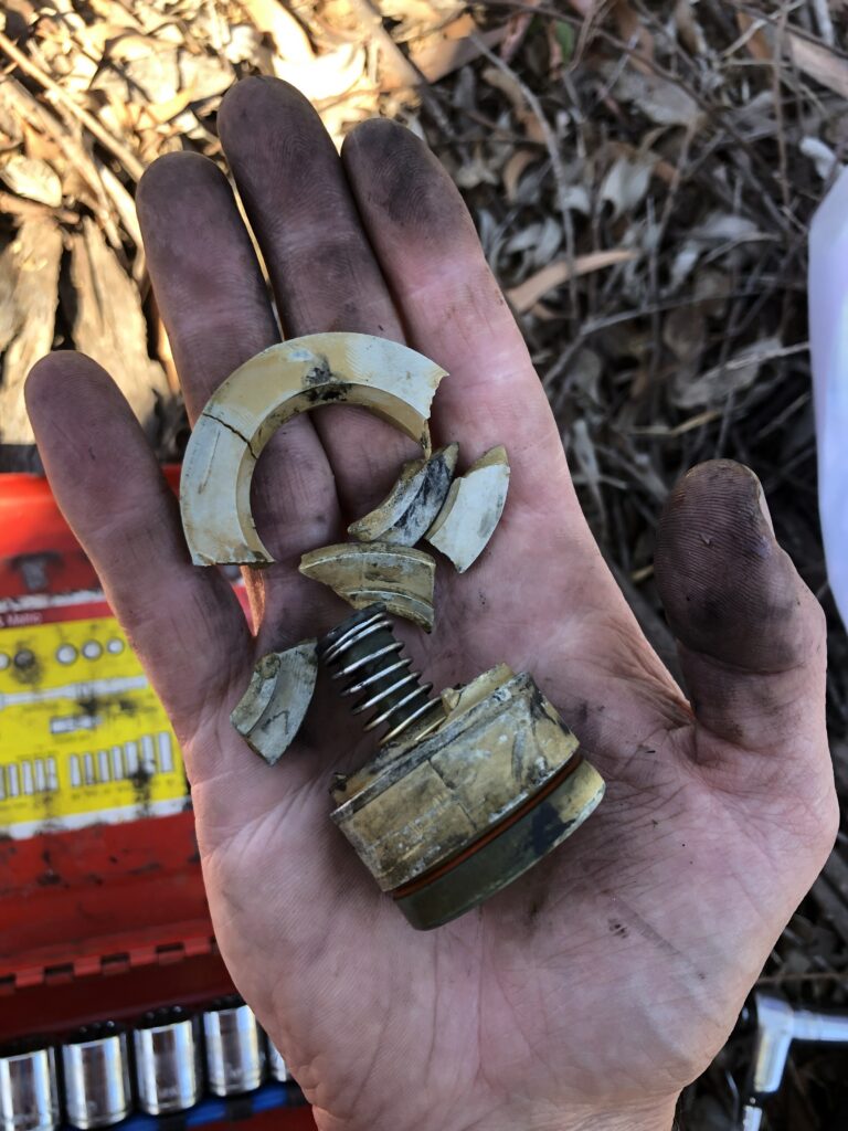 a smashed up check removed from a backflow device double check