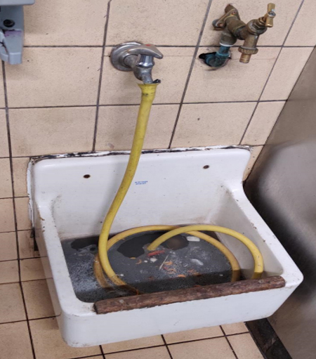Backflow incident hose left in sink with dirty water