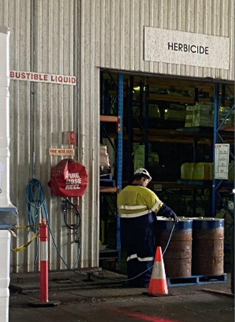 Man adding water to a chemical drum. Potential backflow incident